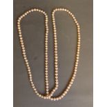 A string of pale pink pearls, 48'' long