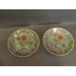 A pair of Chinese green ground dishes decorated with vases, fish and flowers, printed mark to