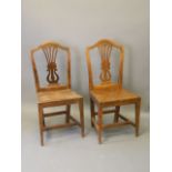 A set of twelve Ottoman solid elm dinning chairs with pierced and lyre backs, on square tapering