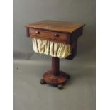 A C19th mahogany single drawer workbox on a turned column platform base with scrolled feet, 21'' x