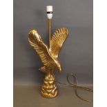 A carved wood and gilt painted table lamp in the form of an eagle, 22½'' high