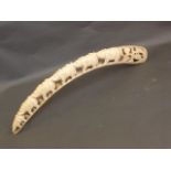 A late C19th/early C20th ivory tusk with carved decoration of a procession of elephants amongst