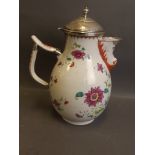 An C18th Chinese Export porcelain jug with enamel flower decoration and gilt highlights, with silver