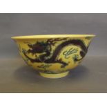 A Chinese yellow ground bowl with painted decoration of green dragons chasing the flaming pearl, 6