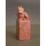 A Chinese rose coloured soapstone seal carved with a kylin to top, 3'' high
