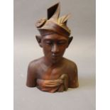 A Balinese carved wood bust of a gentleman in traditional headdress, 10'' high