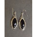 A pair of silver and onyx drop earrings
