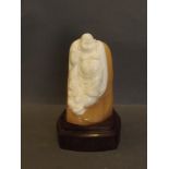 A Chinese soapstone figure of Buddha and a small boy, on a shaped wood stand, 6'' high