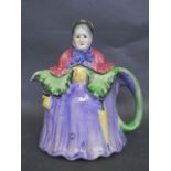 An English novelty teapot in the form of a lady wearing a cape and flowered hat, 8½" high