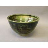 A Studio pottery green glazed ribbed bowl, stamp mark to base, 9½'' diameter