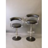 Two chrome and black leather adjustable bar stools, 40'' high