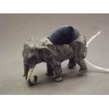 A cold painted bronze figure of an elephant with pin cushion, 2'' high