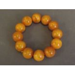 An amber style beaded bangle, 3½'' diameter