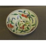 A Chinese Doucai tea bowl decorated with peaches, 6 character mark to base, 4'' diameter