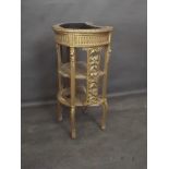 A C19th French giltwood bow fronted jardinière stand with two caned tiers united by carved and