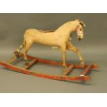 A C19th stuffed and carved wood rocking horse, 45'' long, 24'' high (AF)