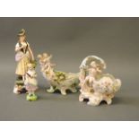 A Continental porcelain centrepiece with cherubs and flowers, another similar, a Continental