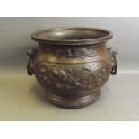 A C19th Oriental bronze twin handled jardinière with raised dragon and phoenix decoration, impressed