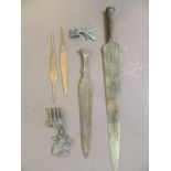 A quantity of Middle Eastern bronze swords, axe heads, and spear blades, 23½'' long