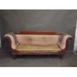 A William IV mahogany sofa with scrolled ends and carved decoration, on carved and turned