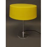 A contemporary chromed metal table lamp by Europa Design, with yellow shade, 19'' high