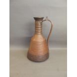 A hammered copper jug with ribbed sides, 14'' high