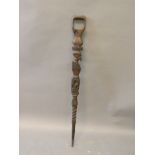 An African carved Macassar wood tribal staff decorated with busts of gentlemen, 36½'' long