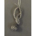 A silver snake pendant and chain set with marcasite