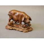 A soapstone carving of a sow with her piglets, 5'' long