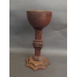 A carved wooden chalice with a shaped base, 11'' high