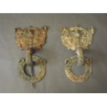 A pair of early Chinese bronze door mounts with raised dragon and phoenix decoration, 24'' long