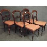 A set of five Victorian mahogany kidney shaped back dining chairs with carved rails and turned