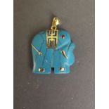 A turquoise and gilt metal pendant carved in the form of an elephant, 1'' square
