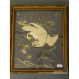 A Japanese embroidery on silk depicting a white hawk, embellished with gold and silver thread,
