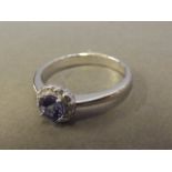 An 18ct white gold tanzanite and diamond cluster dress ring, size O