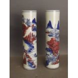 A pair of Chinese blue and white vases decorated with river and mountain landscapes, 9'' high