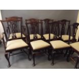 A set of eight Chippendale style dining chairs with pierced back splats and cabriole supports,