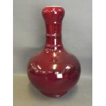 A Chinese long necked sang de boeuf glazed vase, 13½'' high