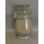 A celadon crackle glazed twin handled vase decorated with calligraphy and symbols, 9'' high