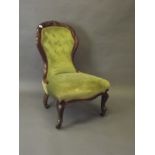 A Victorian walnut nursing chair with shaped and carved back, and serpentine front, on cabriole