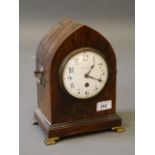 A late C19th lancet shaped rosewood mantle clock, the enamel dial with Arabic numerals, marked '