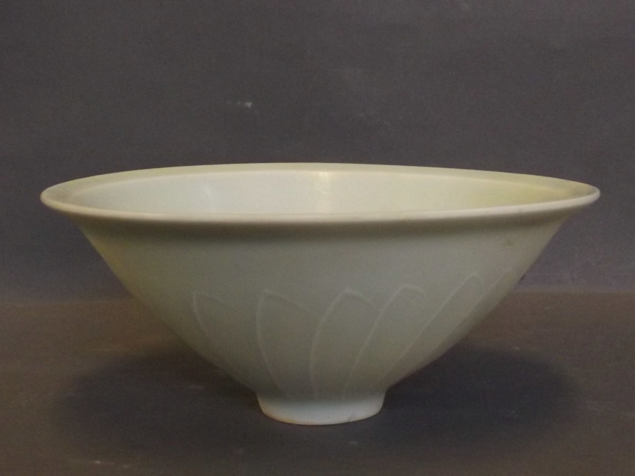 A Chinese celadon bowl with raised petal decoration, 6'' diameter