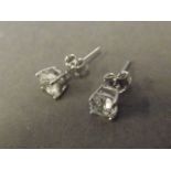 A pair of silver and cubic zirconia ear studs