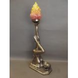 A large Art Deco style table lamp in the form of a nude girl balancing a flame on her foot, 29''