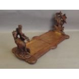 A Black Forest bookslide carved with goats and trees, 14'' long when closed