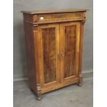 A C19th Continental figured walnut press cupboard, with single frieze drawer over two panelled doors