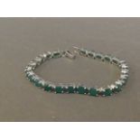 A silver and emerald line bracelet, 8'' long