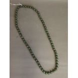 A string of spinach jade beads, 32'' long