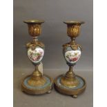 A pair of C19th French porcelain candlesticks with handpainted flower decoration on a blue ground,