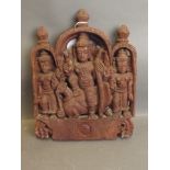A late C19th/early C20th Indian carved wood plaque depicting a warrior with staff astride a peacock,